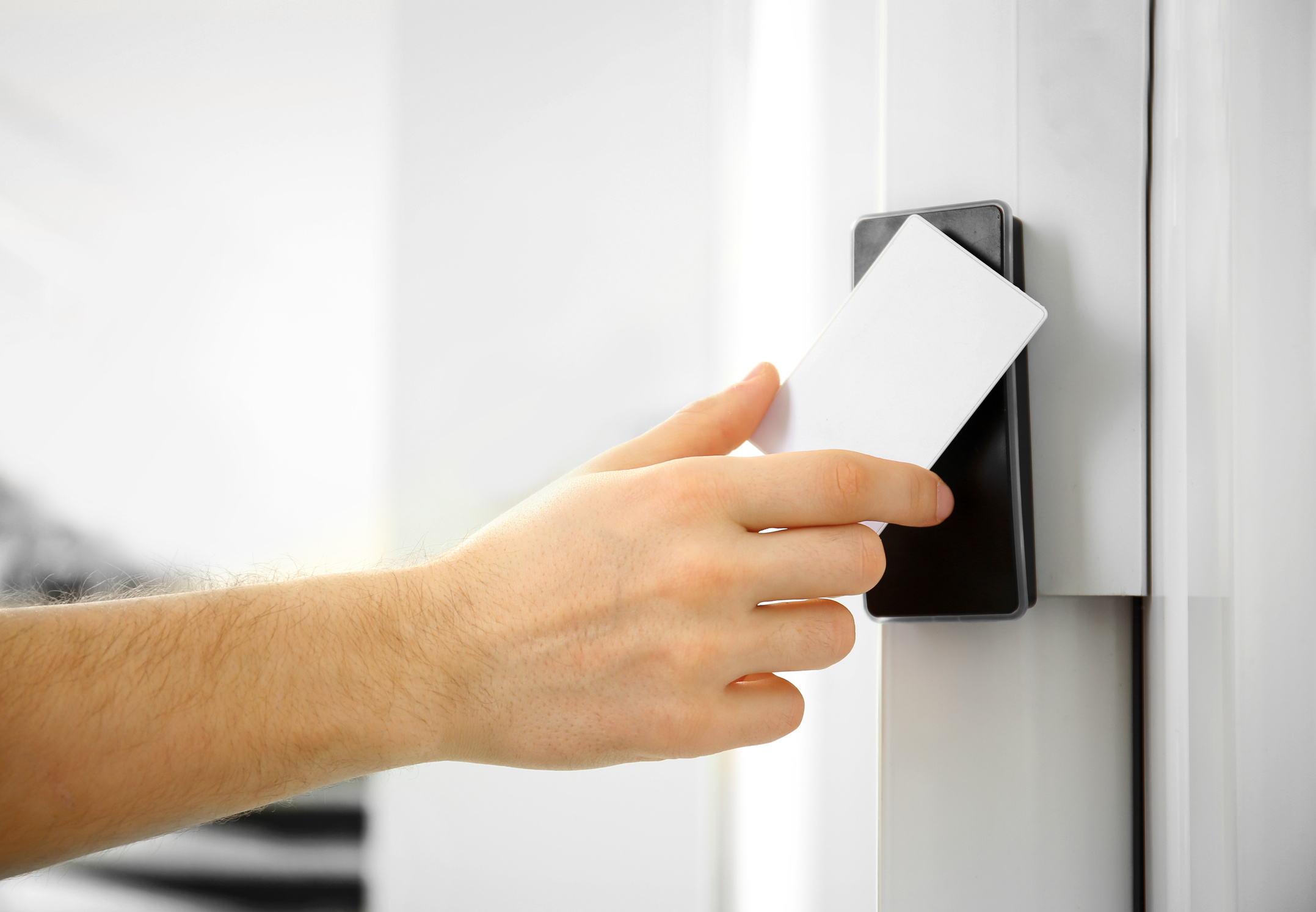 Male Hand Scanning a Security Key Card on the Door 
